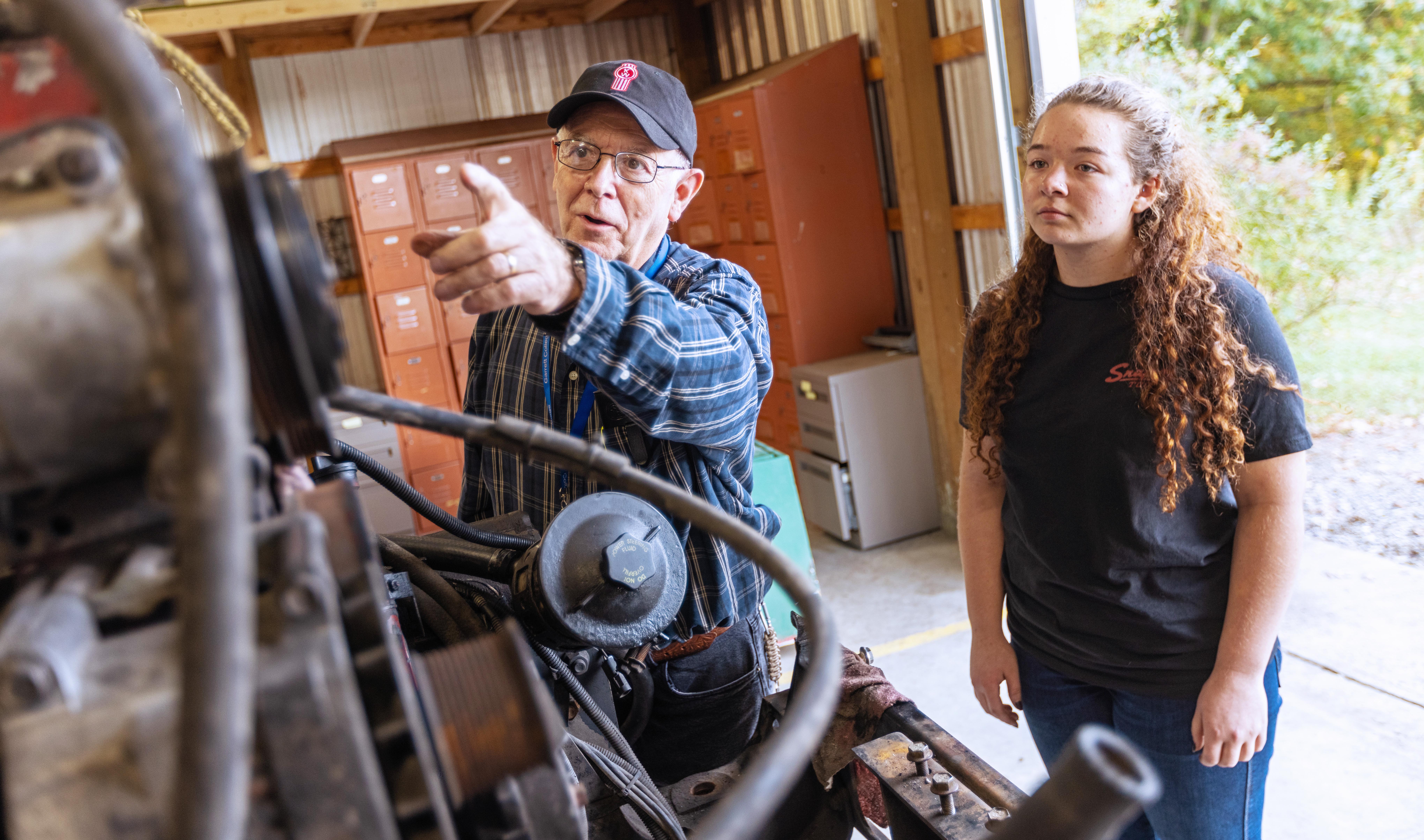 Eliza Wilhelm being instruced by Al Vansickle, captioned below